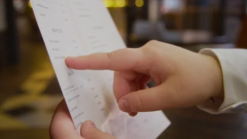 Close up of Unrecognizable Finger Pointing to Positions on Paper Menu Stock Footage 334874865
