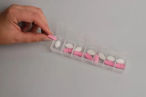 Close-up of unrecognizable girl sorting vitamins into pill organizer Stock Photos