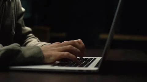 Close-up of unrecognizable hacker man stretching hands and starting to typing on Video stock 142510476