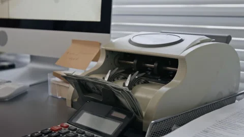Close up of Unrecognizable Hand Placing Stack of Dollar Bills Into Auto Counter Stock Footage 330970854