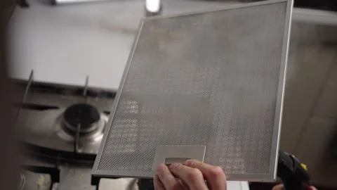 Close-up of unrecognizable homemaker removing grease stains from kitchen hood Stock Footage 305999004