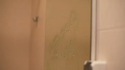 Close-up of unrecognizable housekeeper spraying cleaning solution onto bathroom Stock Footage 297625081
