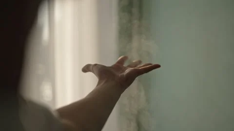 Close-up of unrecognizable man fooling while holding hand out to warm steam Stock Footage 304886886