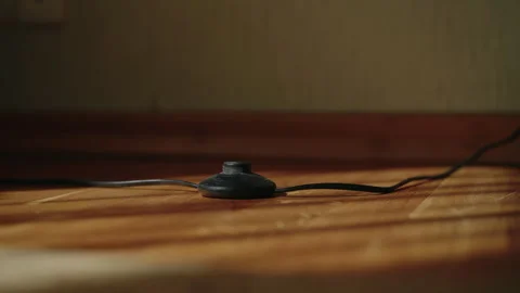 Close-up of unrecognizable man hand pressing foot switch of floor lamp Stock Footage 312351910