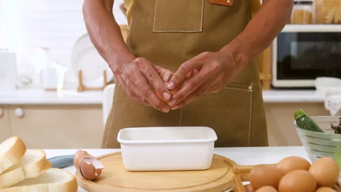Close up unrecognizable man hands cracking eggs in kitchen, Indian male wea.. Stock Footage 255401576