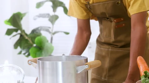 Close up unrecognizable man hands making hot delicious soup in kitchen usin.. Stock Footage 255416605