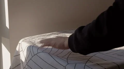 Close up: Unrecognizable man hangs washed bed linen to the dryer in apartment Stock Footage 231510178