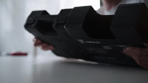 Close-up of unrecognizable man holding new black toolbox, unboxing modern heat Stock Footage 318468656