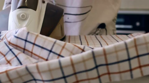 Close-up of an unrecognizable man ironing linen with an iron, a shirt on an Vídeo Stock 155603384