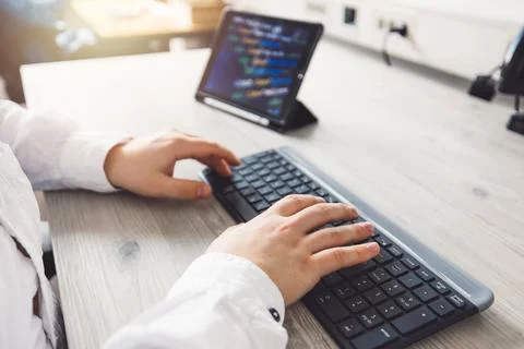 Close up unrecognizable man, programmer typing on a keyboard Stock Photos