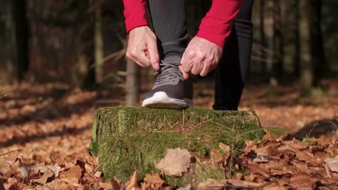 Close up of unrecognizable man putting on his working boots and trying them. Video stock 265942382