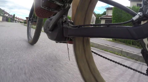 CLOSE UP: Unrecognizable man riding electric bicycle on empty road in suburbs Stock Footage 65586614