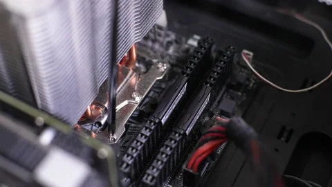 Close-up of unrecognizable man unscrewing screw securing PC CPU air cooling Stock Footage 233701851