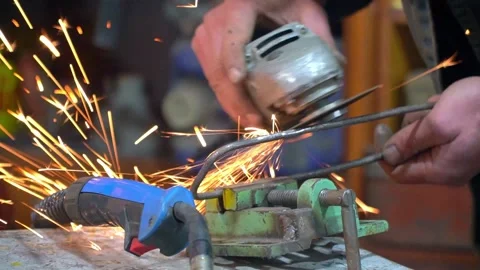 Close-up of unrecognizable master hands grinding metal part clamped with vise Stock Footage 275509859