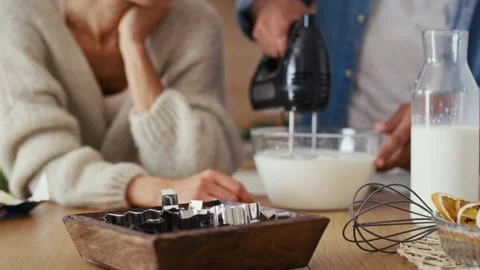 Close up of unrecognizable multi ethnicity couple making a cake together in Chri Stock Footage 218784194