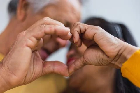 Close up of an Unrecognizable old couple doing a heart Stock Photos