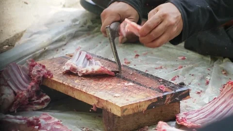 Close-up of unrecognizable people hands cutting fresh raw beef with knives Video stock 338047038