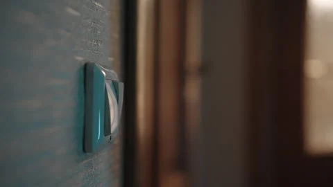 Close-up of unrecognizable person switching electrical wall panel, representing Stock Footage 317161838