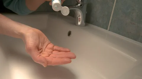 CLOSE UP: Unrecognizable person washes their hands with alcohol hand sanitizer Stock Footage