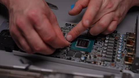 Close-up of unrecognizable technician hands applying new thermal pad onto Stock Footage 290919067