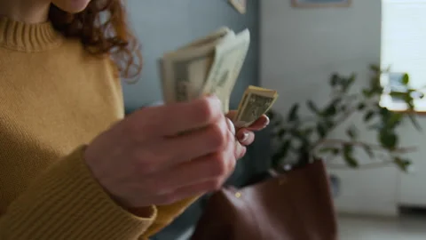 Close-up of Unrecognizable Woman Counting Stack of Dollar Bills in Bank Office Stock Footage 310115264