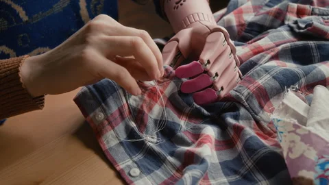 Close-up of Unrecognizable Woman with Disability Fixing Button on Shirt Stock Footage 328359434