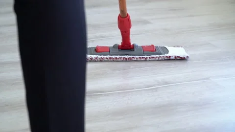 Close-up of unrecognizable woman using mop with microfiber pad while cleaning Stock Footage 156575511