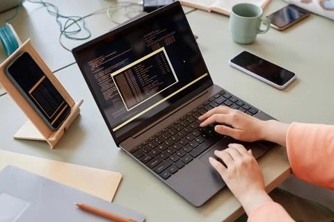 Close up of unrecognizable woman writing code on multiple devices Stockfoto's
