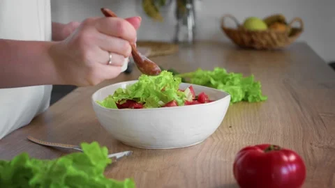Close-up of an unrecognizable woman's hand preparing a salad. Stock Footage 195997615