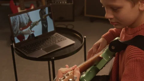 Close Up of Unrecognizable Young Boy Playing Electric Guitar at Home Stock Footage 333423250