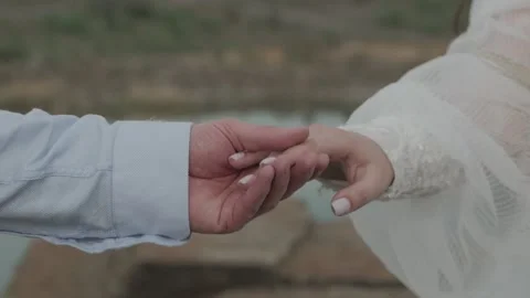 Close-up of an unrecognizable young man and woman holding hands. Stock Footage 154476543