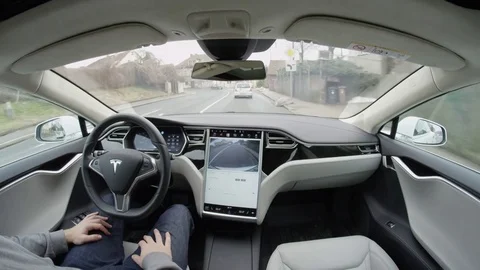 CLOSE UP: Unreliable Tesla Model S self-driving autopilot in city urban areas Stock Footage