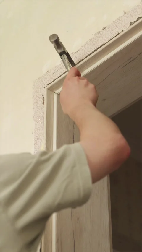 Close up of unscrewing door hinge during frame removal Stock Footage 340610574