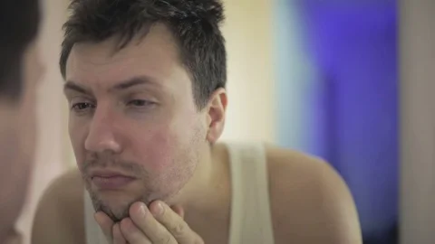 Close up. Unshaven man looking in the mirror. Stock Footage 71314304