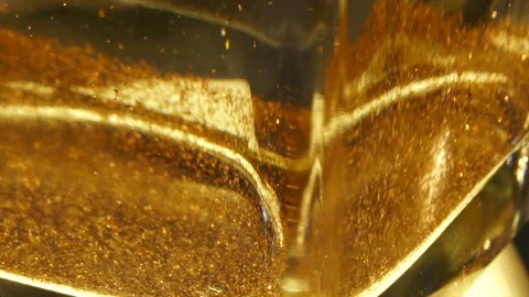 Close uo of Gold glitter in spining water vase Stock Footage 232633626