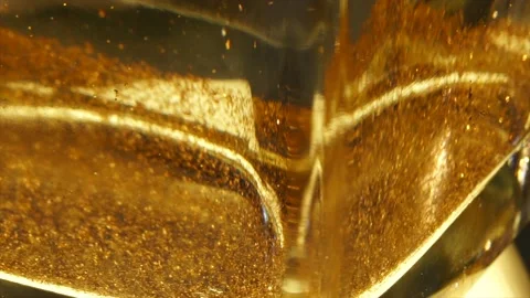 Close uo of Gold glitter in spining water vase 4K Stock-Footage 232634426