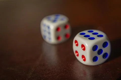 Close uo of two white dices put on a wooden table Stock Photos