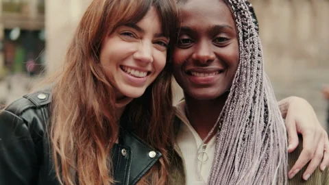 Close-uo of two young female best friends smiling at camera standing at city Stock Footage 305338048