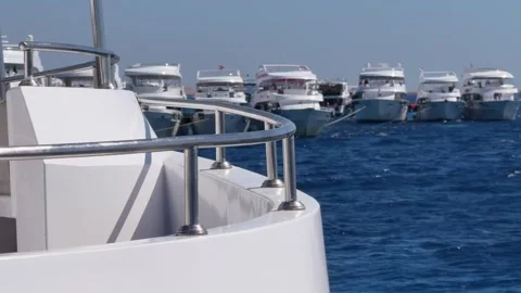 Close up of upper deck railing and group of yachts anchored in the background Stock Footage 340941645