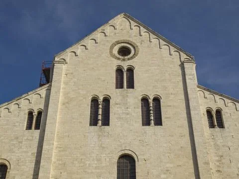 Close-up of the upper facade of an impressive cathedral with windows against a Stock Photos