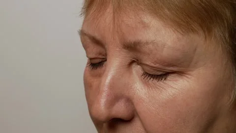 Close-up of the upper face of an elderly woman with brown eyes. Stock Footage 302867202