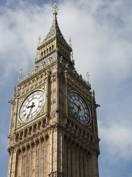 Close-up of the upper part of the Big Ben tower, clock face and clouds in the Stock Photos