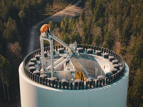 Close-up of the upper part of a wind turbine in front of a forest, wind turbine Stock Photos