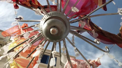 Close-ups of colored fabric carnival flags hanging on a rope and rattling from Video stock 196509692
