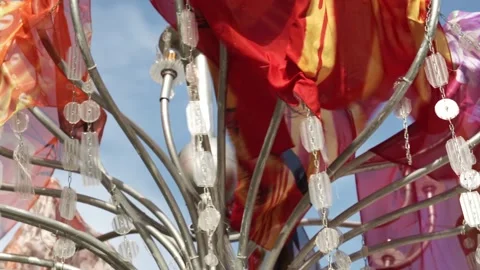 Close-ups of colored fabric carnival flags hanging on a rope and rattling from Video stock 196509732