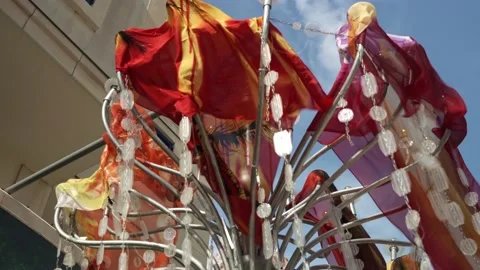Close-ups of colored fabric carnival flags hanging on a rope and rattling from Video stock 196509861