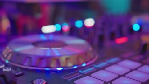 Close ups of DJs controller, turntable, and mixer with CDs. Vibrant atmosphere Stock Footage 268338978
