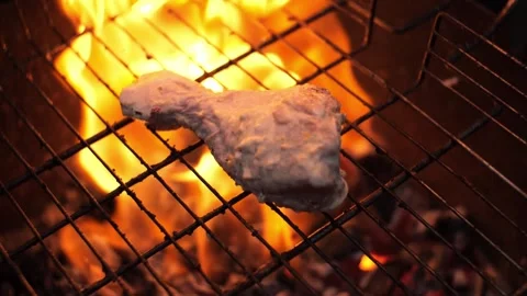 Close-ups, slow motion. Chicken meat lies on the grills over the coals. A Stock Footage 225765156