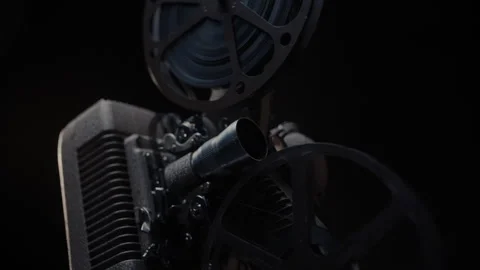 Close ups of a vintage 8MM projector spools moving and playing film Stock Footage 301840888