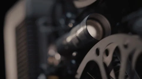 Close ups of a vintage 8MM projector spools moving and playing film Stock Footage 301841145